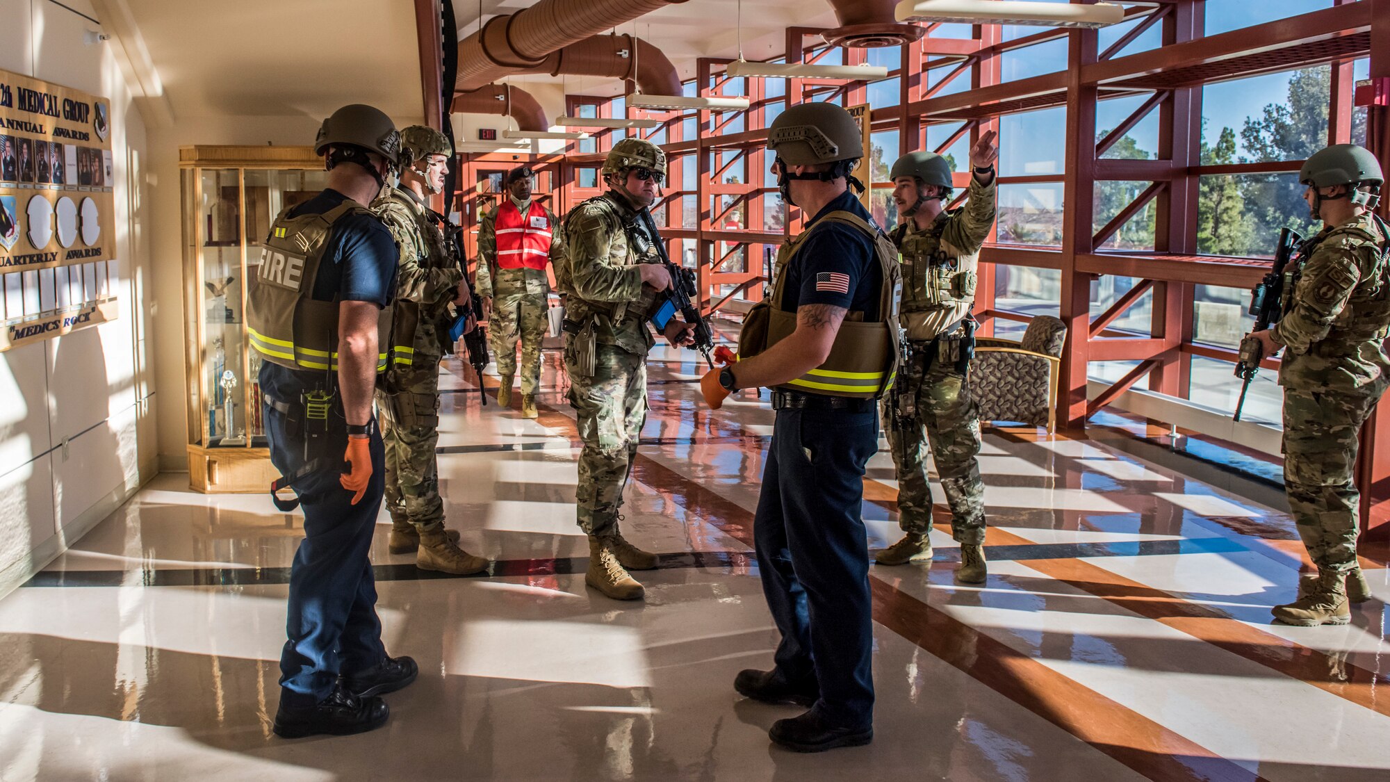 Airmen with the 412th Security Forces confer with members of the Edwards AFB Fire Department during an active shooter exercise at Edwards Air Force Base, California, Feb. 11. (Air Force photo by Richard Gonzales)