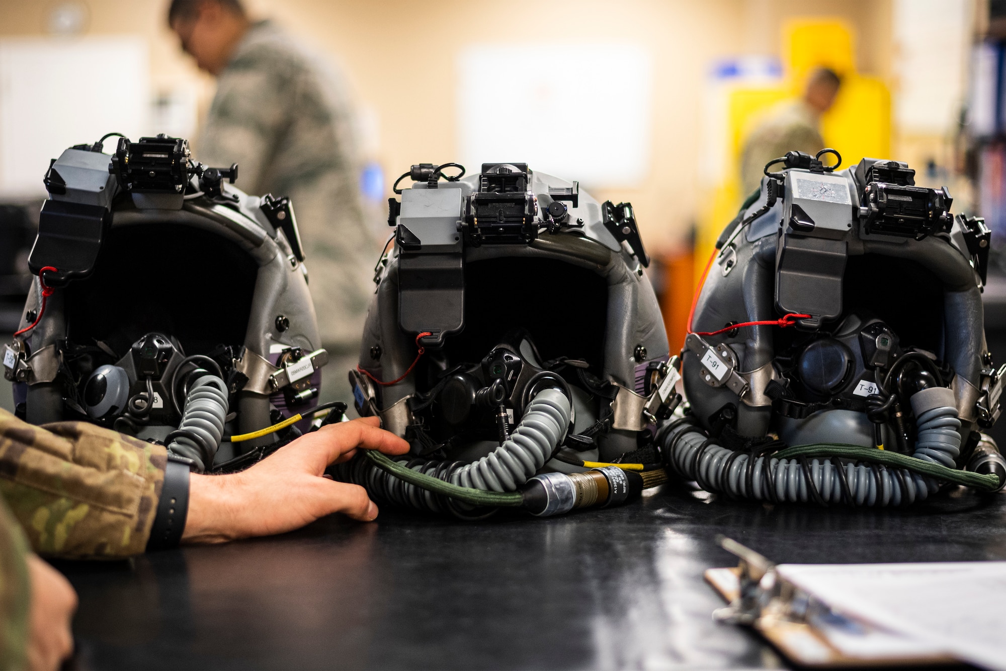 A photo of an Airman inspecting helmets