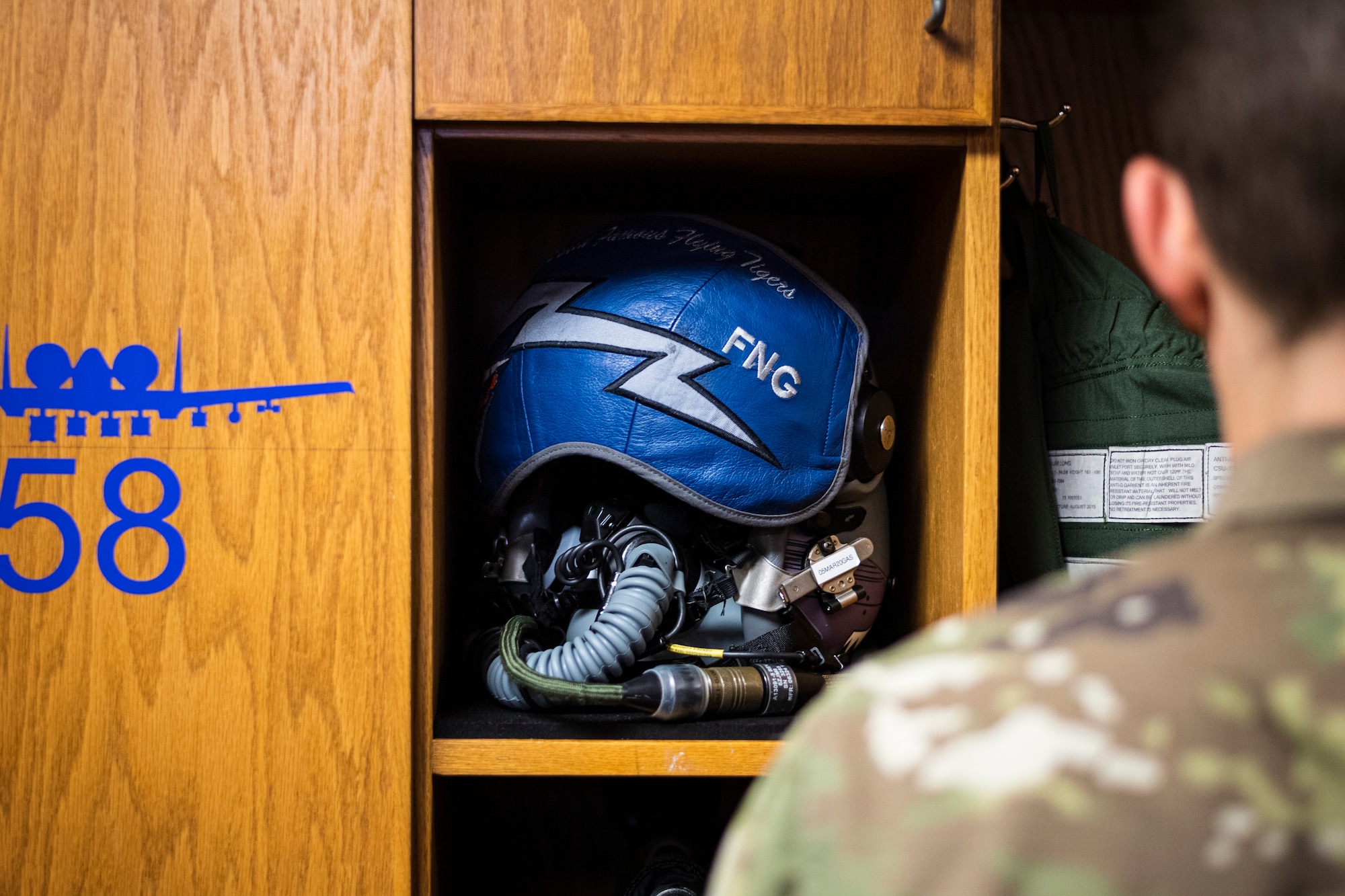 A photo of an Airman performing a locker inspection