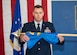 Capt. Daniel Parsons, 412th Security Forces Squadron Det. 1 Commander, unfurls his unit’s guidon during an activation and assumption of command ceremony at the 412th Test Wing Operation Location Plant 42 in Palmdale, California, Feb. 13. (Air Force photo by Giancarlo Casem)