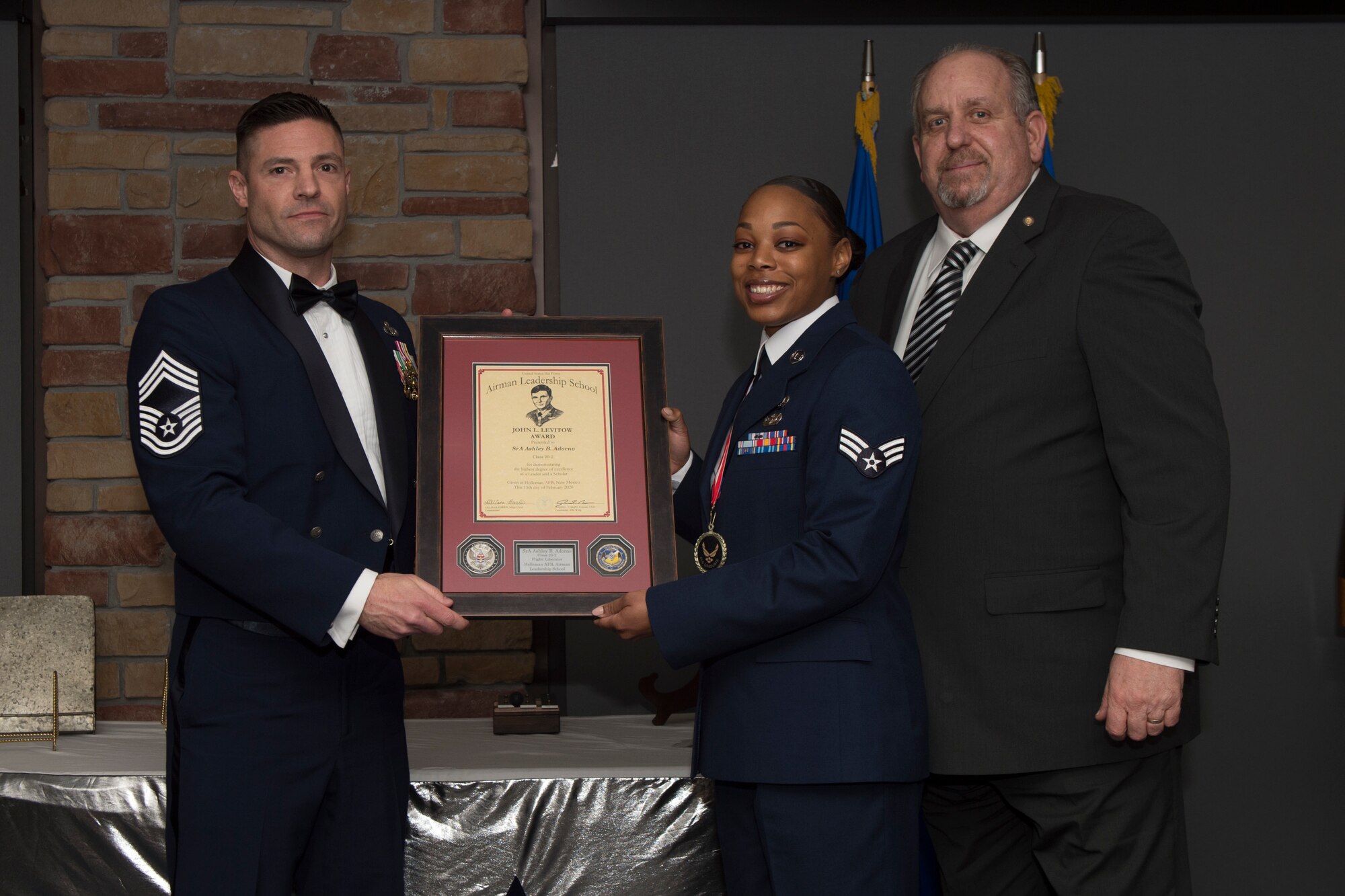 Senior Airman Ashley Adorno, Airman Leadership School graduate, accepts the John L. Levitow award during the graduation of ALS class 20-2, February 13, 2020, on Holloman Air Force Base, N.M. The John L. Levitow award is presented to the student demonstrating the highest level of leadership and scholastic performance, and is determined by the assignment of points by their peers. (U.S. Air Force photo by Airman 1st Class Kristin Weathersby).