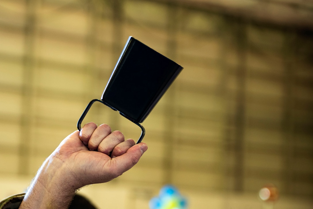 An Airman with the 23d Medical Group rings a cowbell in celebration during the Annual Awards Ceremony Feb. 14, 2020, at Moody Air Force Base, Georgia. The ceremony recognized the top military and civilian personnel in 10 separate categories. (U.S. Air Force photo by Senior Airman Erick Requadt)