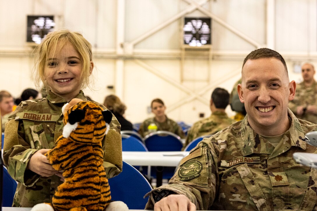 Maj. Jeffrey Durham, right, 23d Operations Support Squadron intelligence flight commander, and his daughter, Grace, pose for a photo during the Annual Awards Ceremony Feb. 14, 2020, at Moody Air Force Base, Georgia. The ceremony recognized the top military and civilian personnel in 10 separate categories. (U.S. Air Force photo by Senior Airman Erick Requadt)