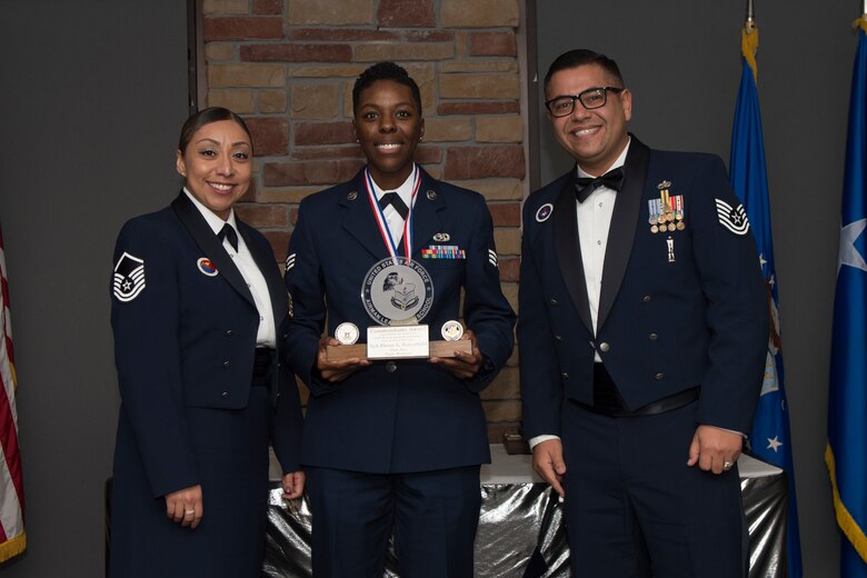 Senior Airman Ebony Satterfield, Airman Leadership School graduate, accepts the commandant leadership award during the graduation of ALS class 20-2, February 13, 2020, on Holloman Air Force Base, N.M. The commandant leadership award is selected by the ALS commandant, and is presented to the student who demonstrates the characteristics of an effective leader. (U.S. Air Force photo by Airman 1st Class Kristin Weathersby).