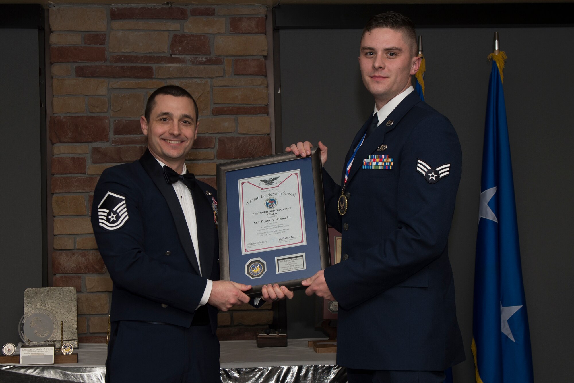 Senior Airman Troy Taylor Sochovka, Airman Leadership School graduate, accepts the distinguished graduate award during the graduation of ALS class 20-2, Feb.13, 2020, on Holloman Air Force Base, N.M. The distinguished graduate award is presented to the top ten-percent of graduates for their performance in academic evaluations and demonstration of leadership. (U.S. Air Force photo by Airman 1st Class Kristin Weathersby).