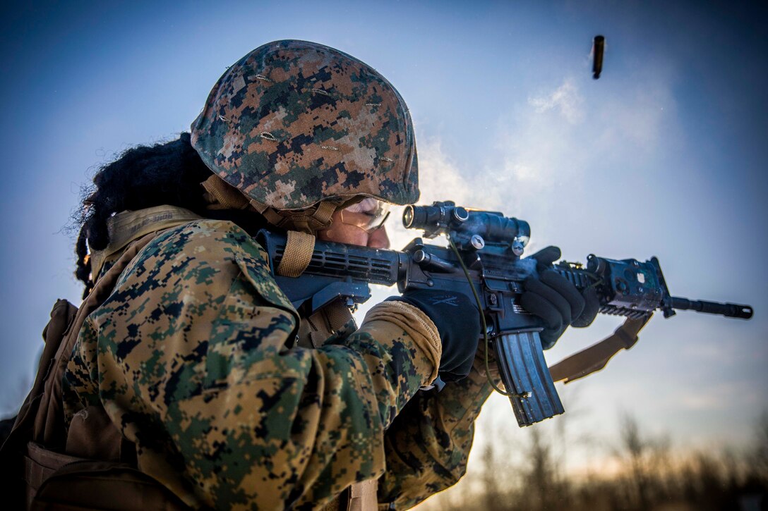 A Marine fires a rifle.