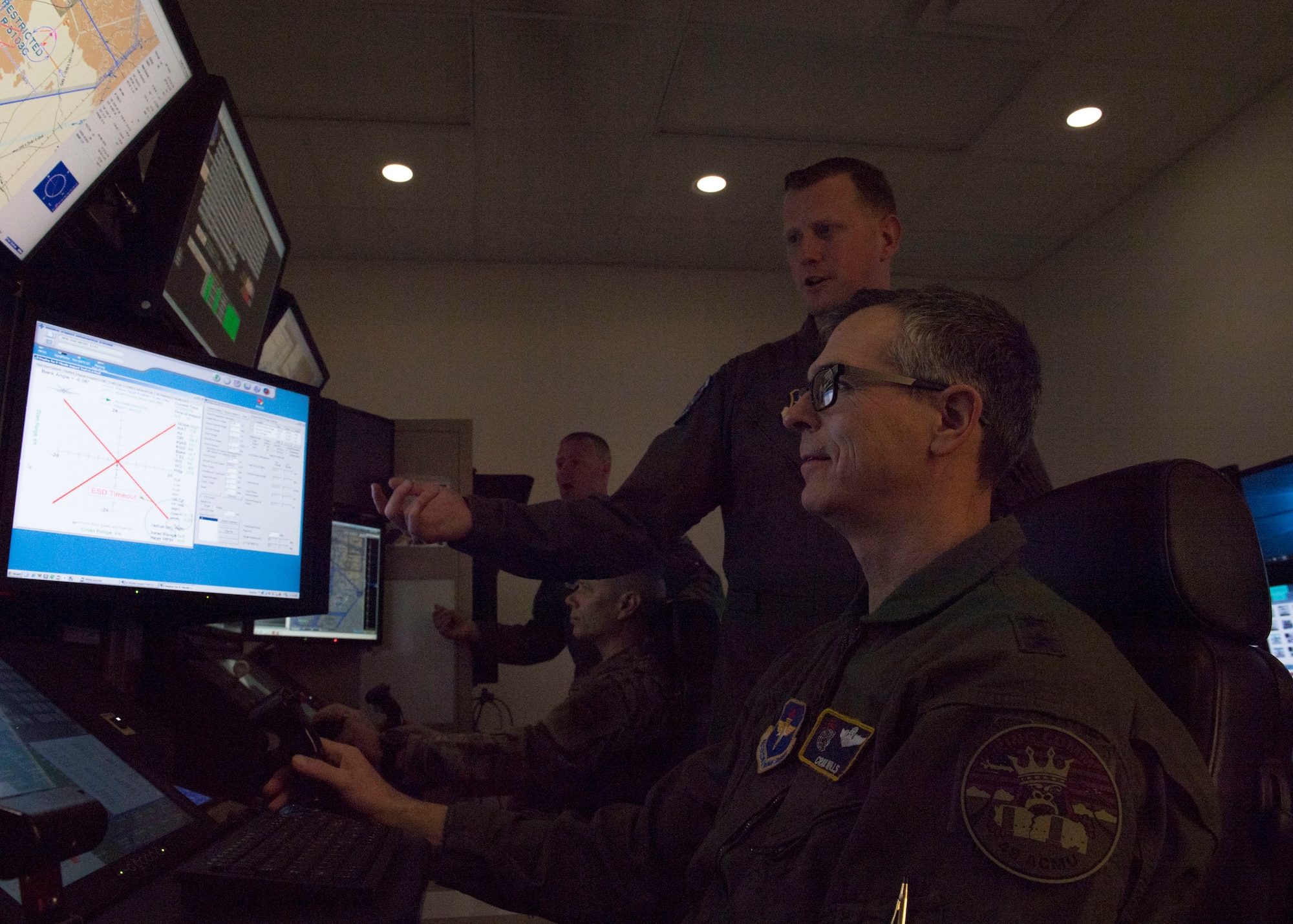 Maj. Gen. Craig D. Wills, 19th Air Force commander, flies an MQ-9 simulator with direction from Capt. Christopher, 6th Attack Squadron flight commander, Feb. 13, 2020, on Holloman Air Force Base, N.M. The 16th Attack Squadron uses MQ-9 simulators to train pilots and sensor operators for their field. (U.S. Air Force photo by Airman 1st Class Autumn Vogt)
