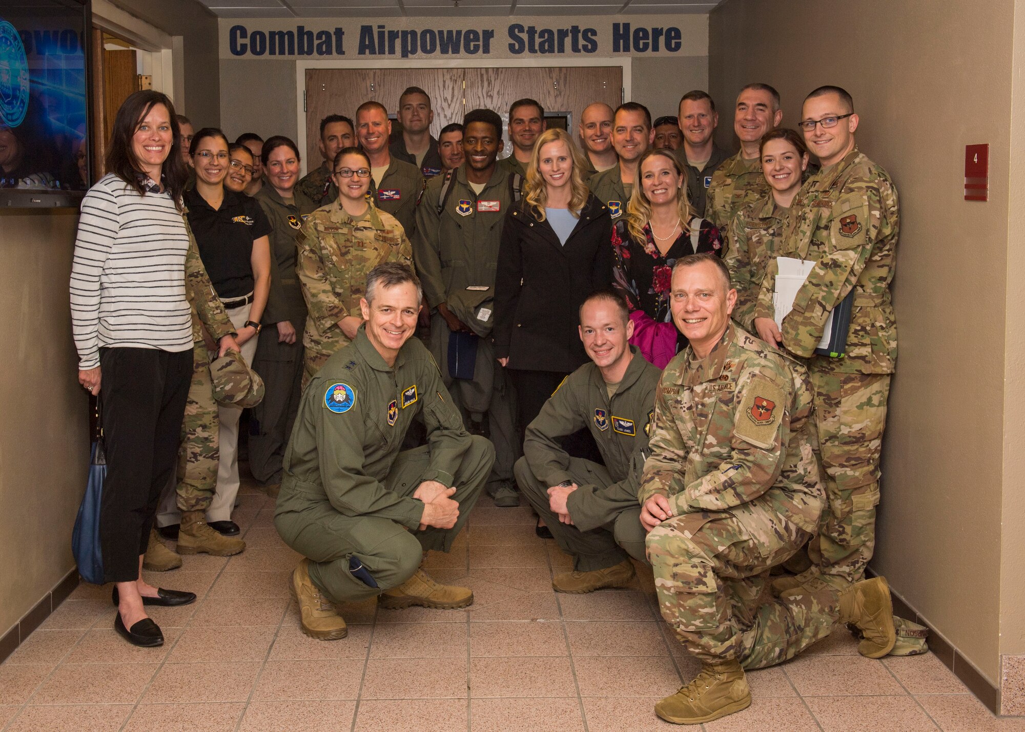 Airmen and spouses involved in the 19th Air Force command team tour, pose for a picture, Feb. 13, 2020, on Holloman Air Force Base, N.M. The 19th AF command team toured 49th Wing facilities, focusing on recognizing Airmen making an impact on the mission. (U.S. Air Force photo by Airman 1st Class Autumn Vogt)