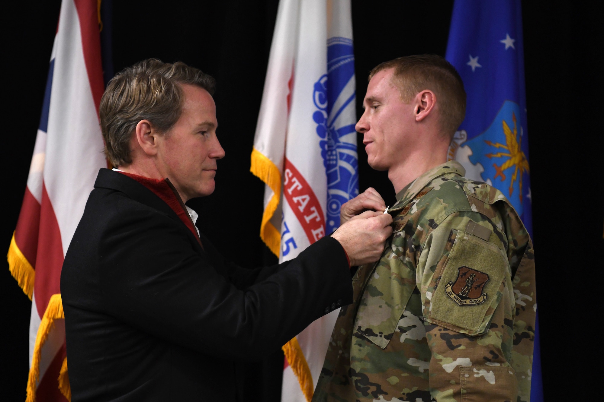 Ohio’s Lt. Governor Jon Husted awards the Ohio Cross to U.S. Air Force Master Sgt. Ryan Tucker during the Ohio National Guard’s Joint Senior Leaders Conference Feb. 14, 2020 in Columbus, Ohio. The Ohio Cross is awarded to any member of the state military forces who distinguishes themselves by gallantry and intrepidity at the risk of their life. (U.S. Air Force photo by Tech. Sgt. Shane Hughes)