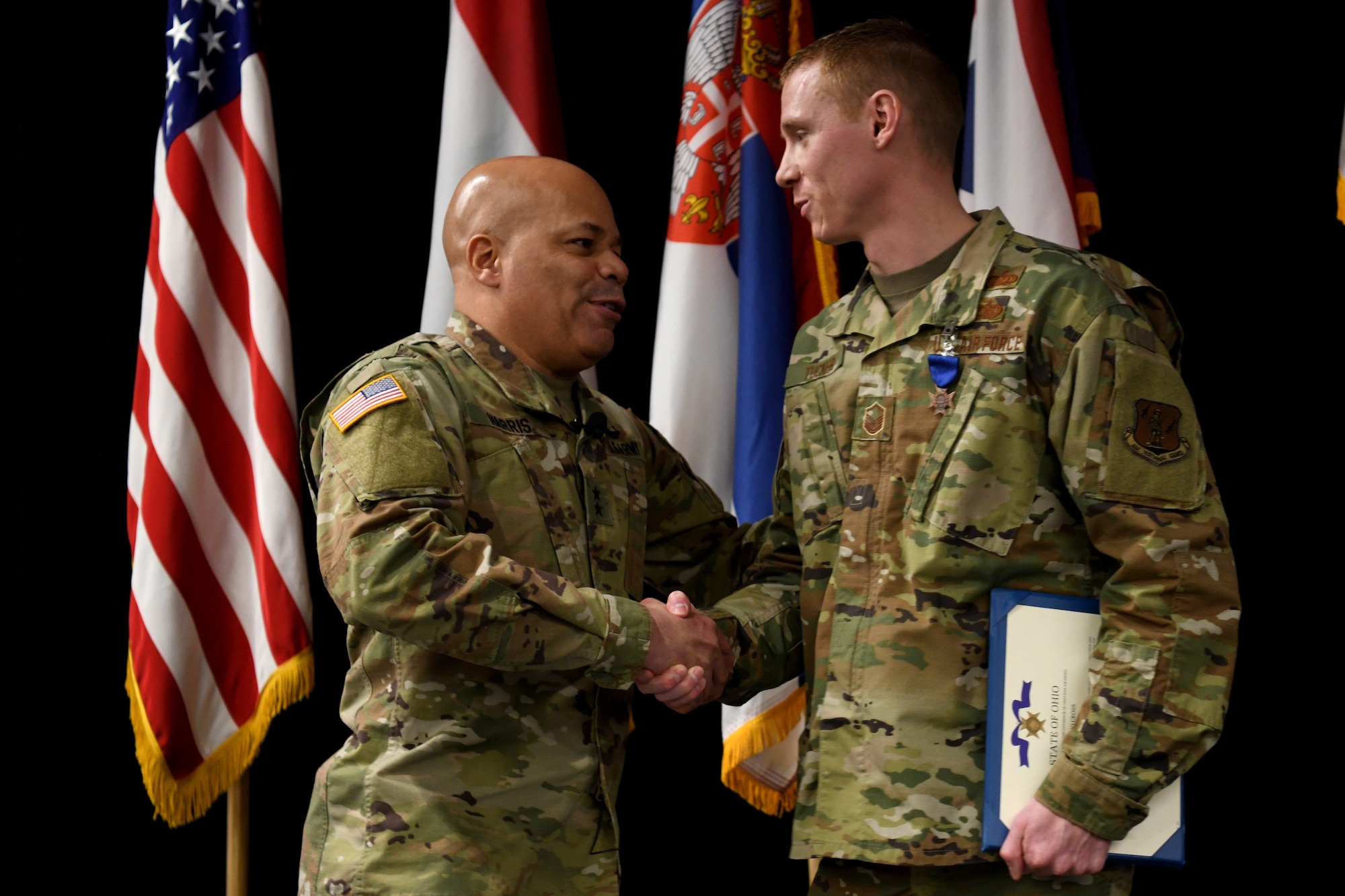U.S. Army Maj. General John C. Harris, the Ohio Adjutant General, congratulates U.S. Air Force Master Sgt. Ryan Tucker after Ohio’s Lt. Governor Jon Husted awarded Tucker the Ohio Cross during a ceremony at the Ohio National Guard’s Joint Senior Leaders Conference Feb. 14, 2020 in Columbus, Ohio. The Ohio Cross is awarded to any member of the state military forces who distinguishes themselves by gallantry and intrepidity at the risk of their life. (U.S. Air Force photo by Tech. Sgt. Shane Hughes)