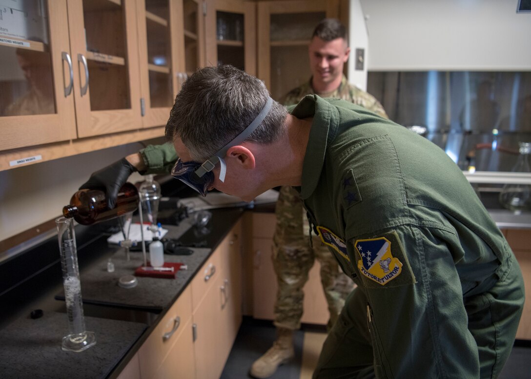 Maj. Gen. Craig Wills, 19th Air Force commander, pours a sample into a graduated cylinder, Feb. 14, 2020, on Holloman Air Force Base, N.M. Staff Sgt. Christopher Schaver, 49th Logistics readiness squadron fuels laboratory noncommissioned officer in charge, showed Wills how to sample jet fuel in order to demonstrate daily operations. (U.S. Air Force photo by Airman 1st Class Quion Lowe)