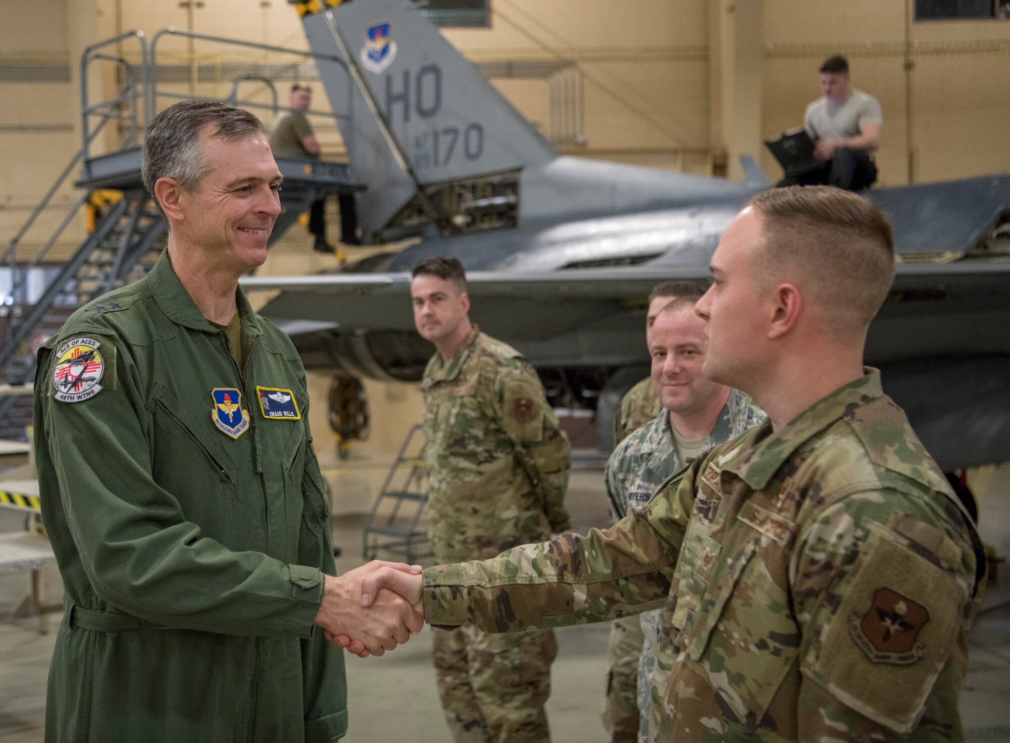 Maj. Gen. Craig Wills, left, 19th Air Force commander, greets a 49th Maintenance Group Airman, Feb. 14, 2020, on Holloman Air Force Base, N.M. The 19th AF command team toured 49th Wing facilities, focusing on recognizing Airmen who have made a substantial impact on the Holloman mission. (U.S. Air Force photo by Airman 1st Class Quion Lowe)