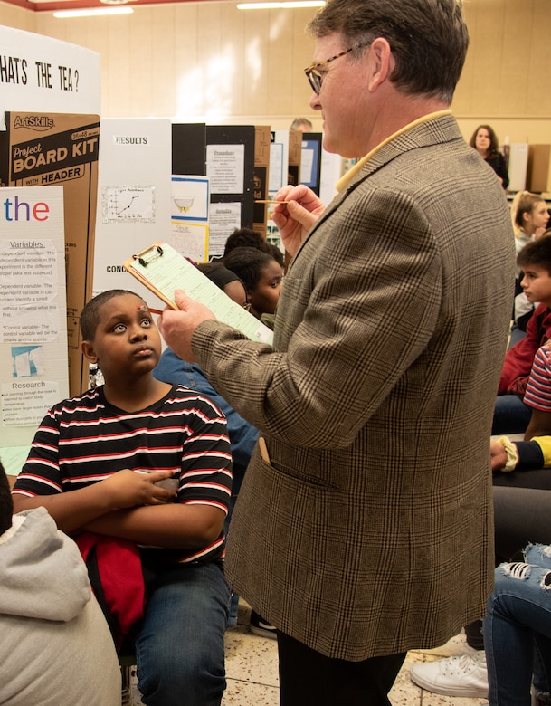 Bruce Railey, a project manager with Global Operations, Ordnance and Explosives Directorate, at the U.S. Army Engineering and Support Center, Huntsville, interviews a sixth-grade student during Williams Middle School’s science fair in Huntsville, Alabama, Jan. 30, 2020. Nearly 200 sixth-, seventh- and eighth-graders presented projects at the school’s fair.