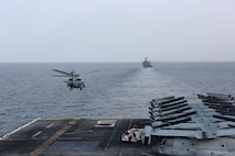 A U.S. Navy MH-60S Sea Hawk helicopter departs from the amphibious assault ship USS Bataan (LHD 5). The Bataan Amphibious Ready Group, with embarked 26th Marine Expeditionary Unit, is deployed to the U.S. 5th Fleet area of operations in support of naval operations to ensure maritime stability and security in the Central Region, connecting the Mediterranean and the Pacific through the western Indian Ocean and three strategic choke points. (U.S. Marine Corps photo by Cpl. Nathan Reyes/Released)