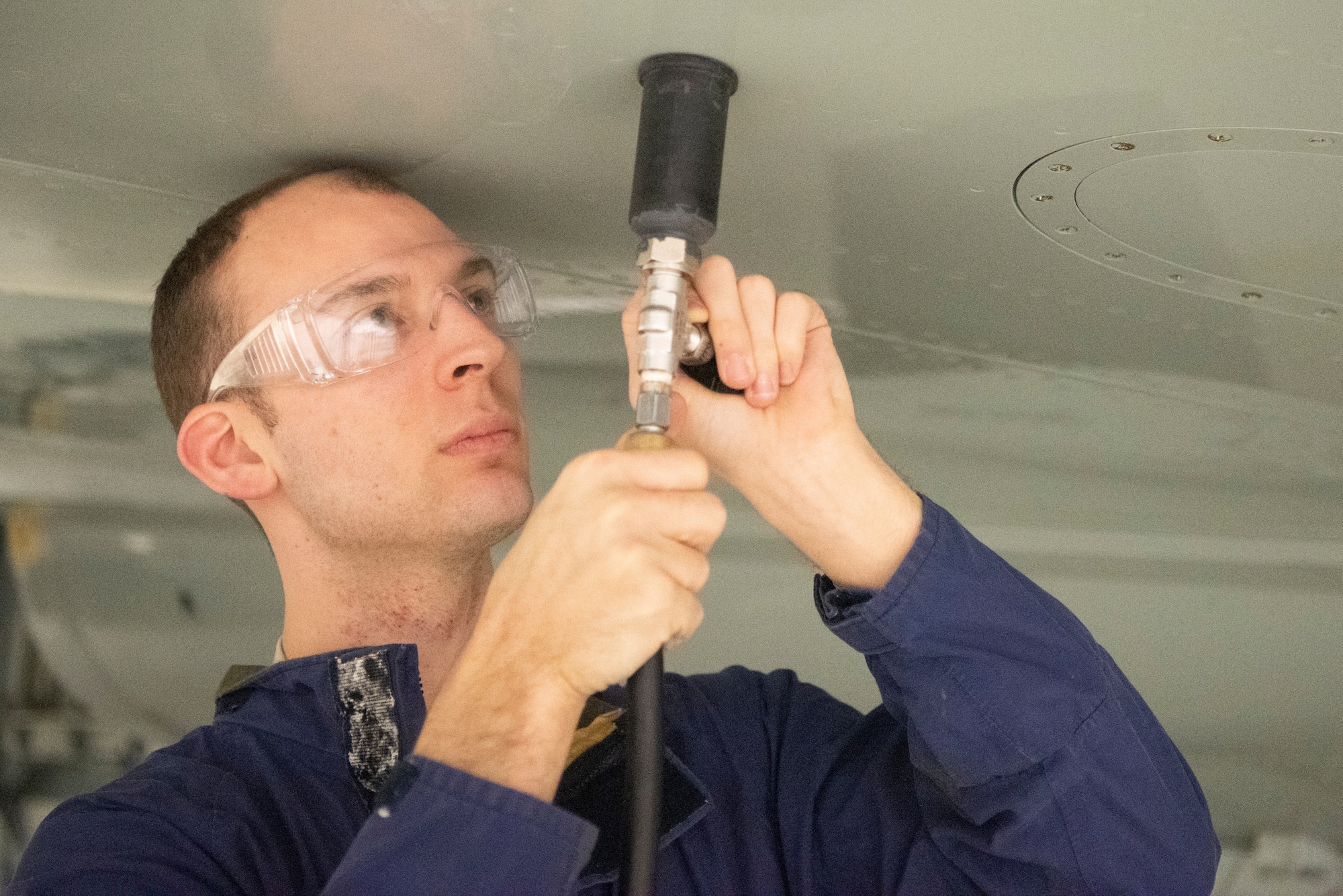 Staff Sgt. Patrick Leach, 100th Maintenance Squadron aircraft fuels systems craftsman, uses the Pressurized Leak Detection Cup he designed Feb. 14, 2020, at RAF Mildenhall, England. The device has reduced leak detection time in fuel tanks by 75 percent and can potentially save the base more than $1 million annually. (U.S. Air Force photo by Airman 1st Class Joseph Barron)