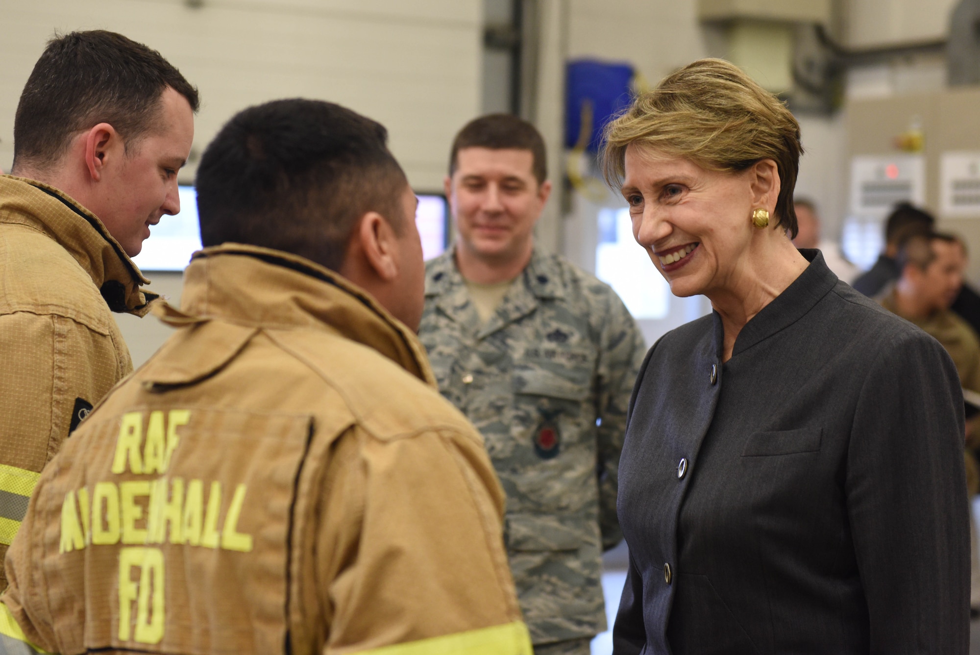 Secretary of the Air Force Barbara Barrett meets with Airmen from the 100th Civil Engineer Squadron fire department during her visit to RAF Mildenhall, England, Feb. 13, 2020.  Barrett stopped at the air traffic control tower, fire station and various units within the 352 Special Operations Wing during her visit. (U.S. Air Force photo by Staff Sgt. Luke Milano)