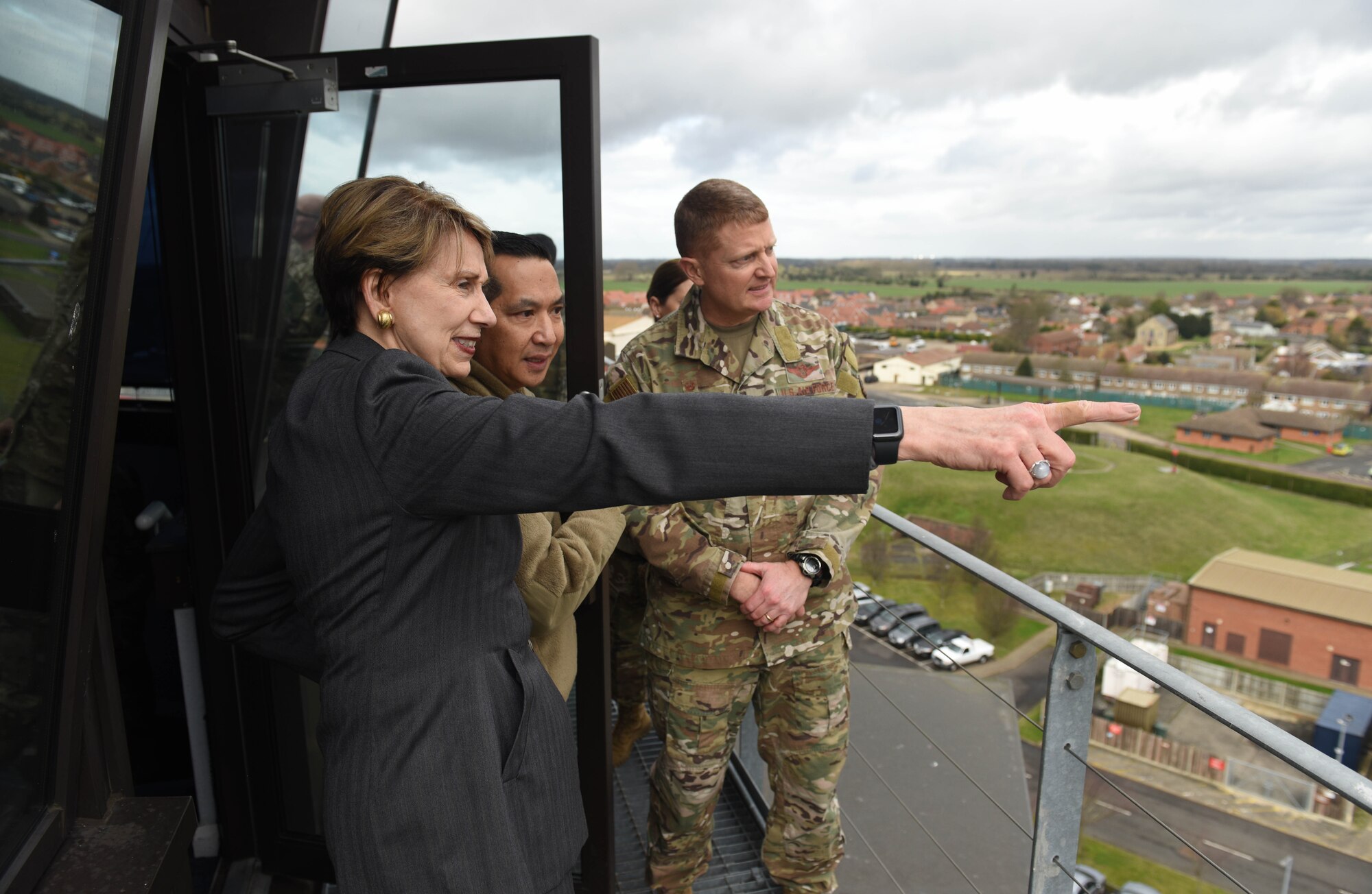 Secretary of the Air Force Barbara Barrett looks out over the base and surrounding community with Col. Troy Pananon, 100th Air Refueling Wing commander, and Col. Clay Freeman, 352 Special Operations Wing commander, atop the air traffic control tower during her visit to RAF Mildenhall, England, Feb. 13, 2020. During Barrett’s visit she spoke to members of RAF Mildenhall about Team Mildenhall’s mission, Air Force modernization and listen to their innovative ideas on how to improve the base. (U.S. Air Force photo by Staff Sgt. Luke Milano)