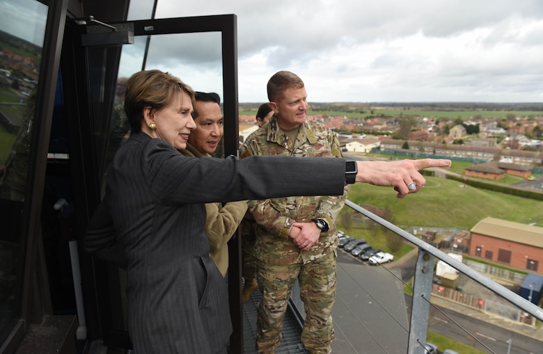 Secretary of the Air Force Barbara Barrett looks out over the base and surrounding community with Col. Troy Pananon, 100th Air Refueling Wing commander, and Col. Clay Freeman, 352 Special Operations Wing commander, atop the air traffic control tower during her visit to RAF Mildenhall, England, Feb. 13, 2020. During Barrett's visit she spoke to members of RAF Mildenhall about Team Mildenhall's mission, Air Force modernization and listen to their innovative ideas on how to improve the base. (U.S. Air Force photo by Staff Sgt. Luke Milano)