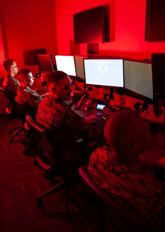 Marines with Marine Corps Forces Cyberspace Command pose for photos in cyber operations room at Lasswell Hall aboard Fort Meade, Maryland, Feb. 5, 2020. MARFORCYBER Marines conduct offensive and defensive cyber operations in support of United States Cyber Command and operate, secure and defend the Marine Corps Enterprise Network.