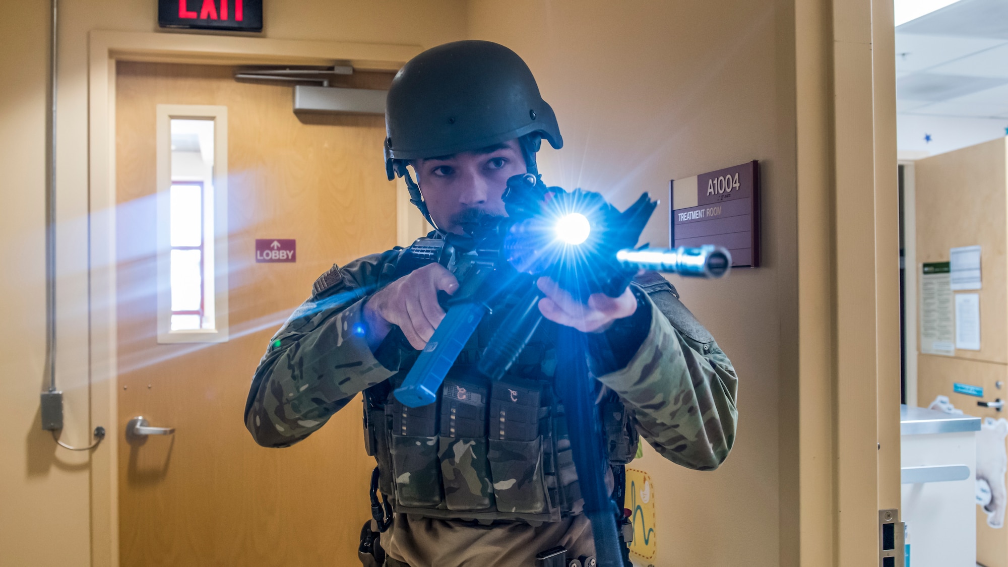 Senior Airman Richard Nicholas, 412th Security Forces Squadron, moves down a hallway to secure it during an active shooter exercise at Edwards Air Force Base, California, Feb. 11. (Air Force photo by Richard Gonzales)