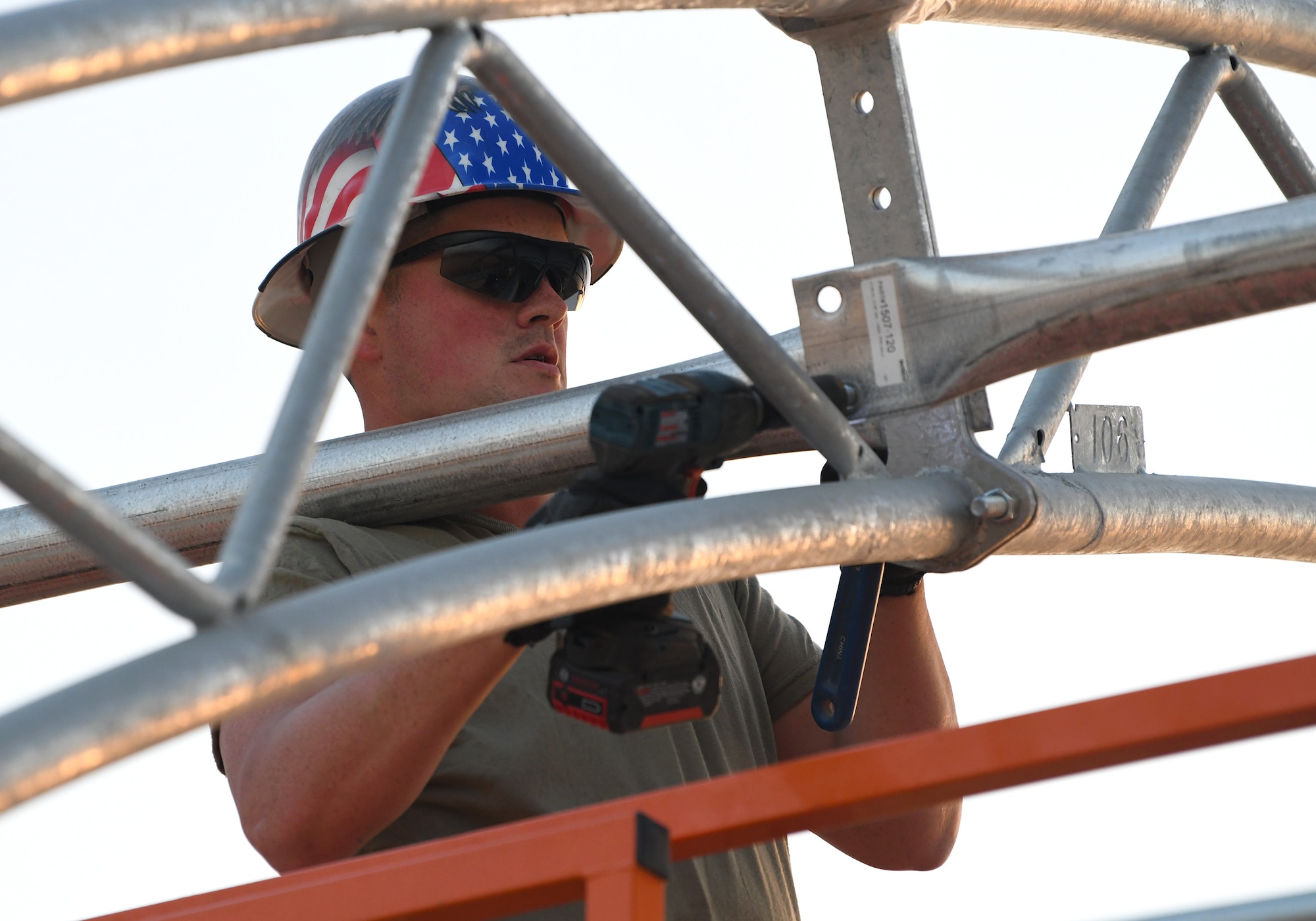 Photo of Airmen constructing an outdoor gym.