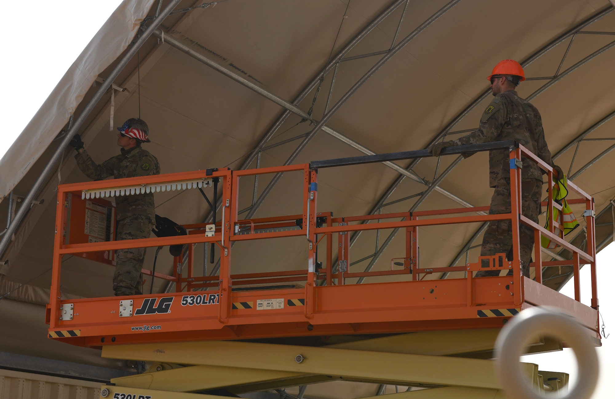 Photo of Airmen constructing an outdoor gym.