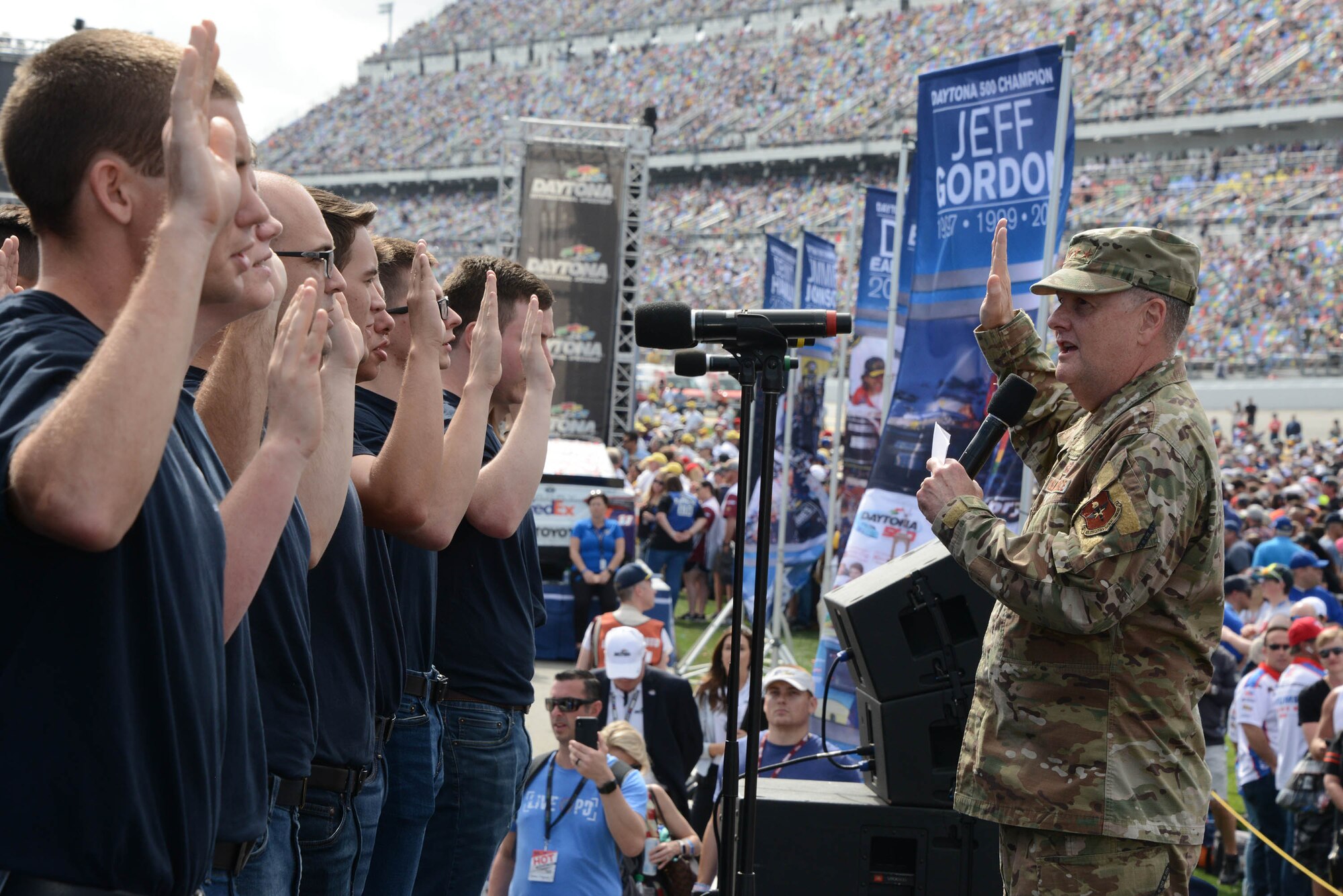 Lt. Gen. Brad Webb, Air Education and Training commander, conducts a Total Force mass oath of enlistment to 30 new members of the Air Force at the Daytona 500.