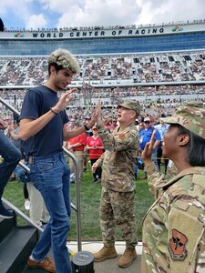 General high-fives a new Air Force enlistee