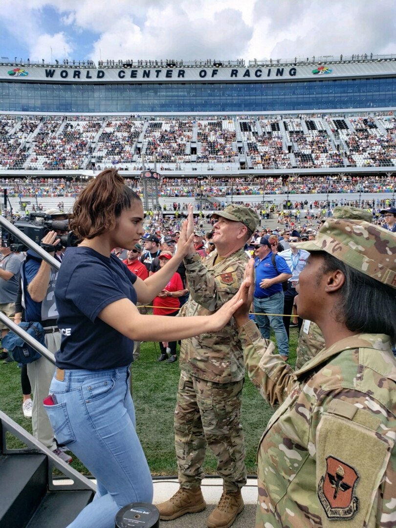 General high-fives one of the Air Force's newest enlistees