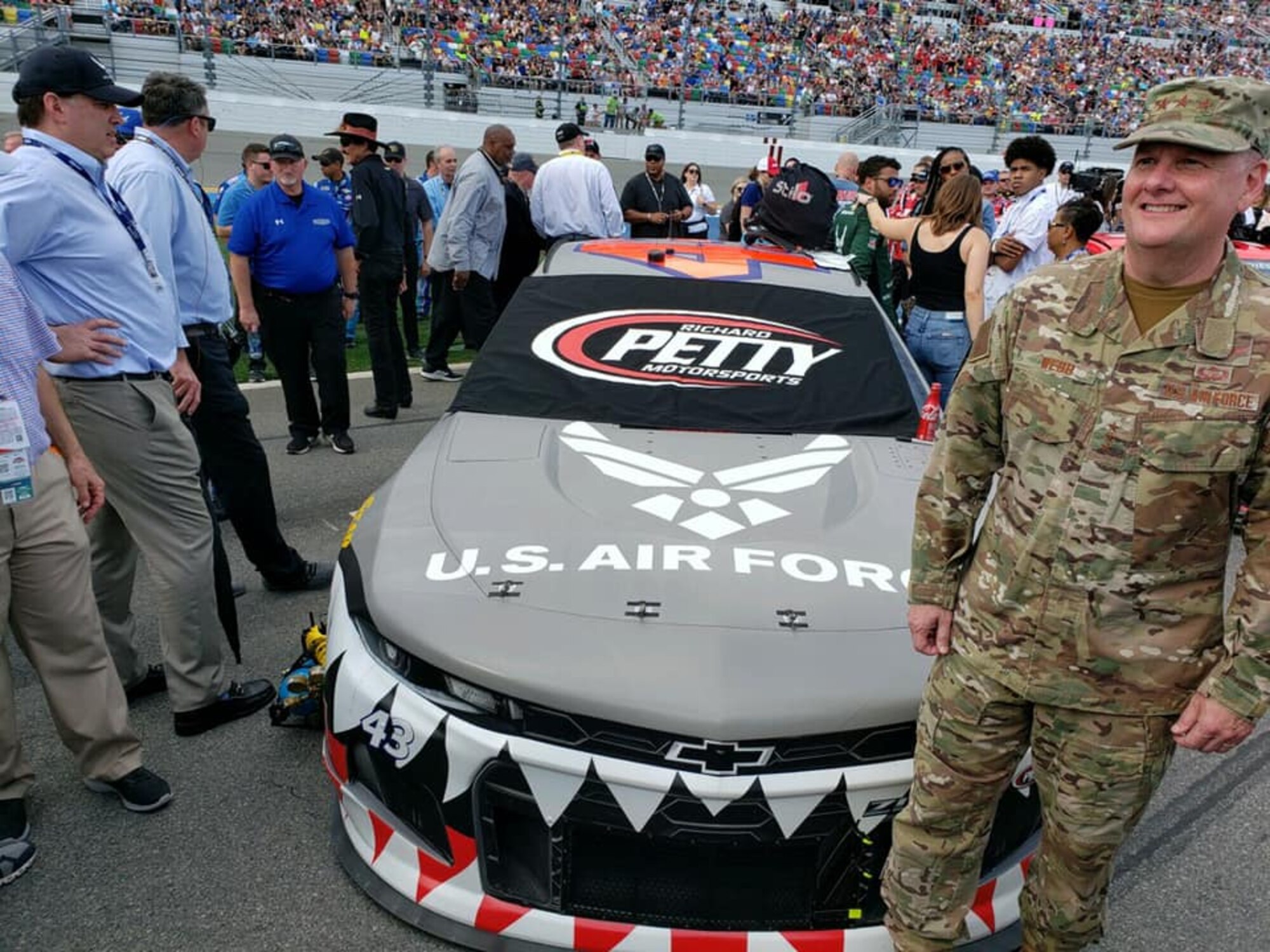 General Webb standing next to a race car