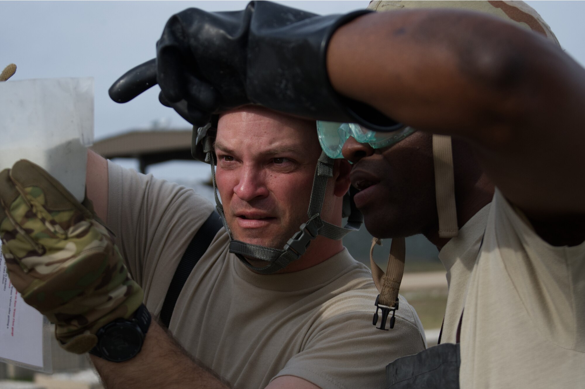 Photo of two Airmen measuring chemicals.