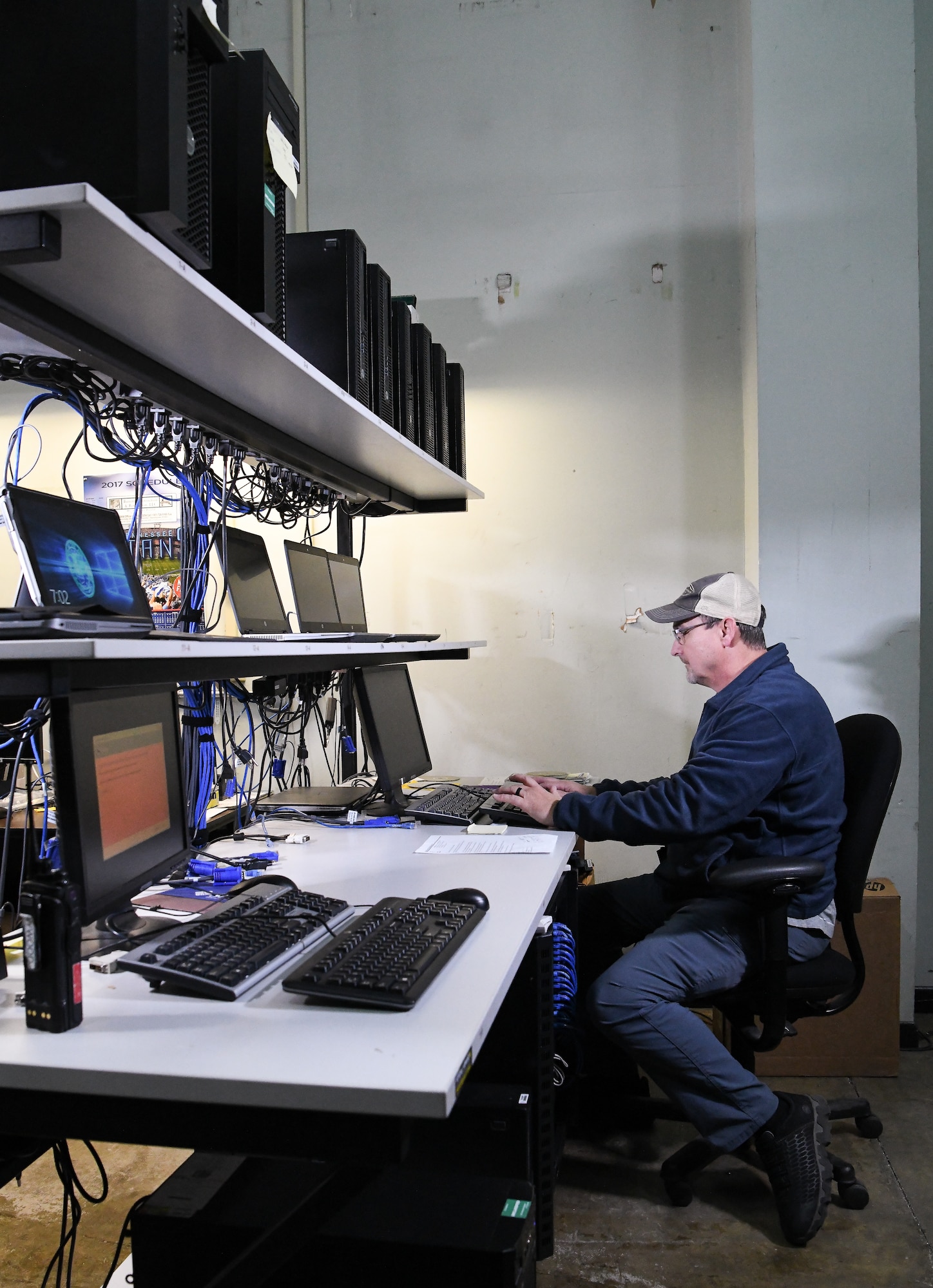 Troy Haywood, lead computer network technician, restages a computer for Non-Classified Internet Protocol Router Network, Dec. 12, 2019, in the PC Staging Area at Arnold Air Force Base, Tenn. Computers must be loaded with required software and necessary security protocols prior to being deployed for use by AEDC team members. (U.S. Air Force photo by Jill Pickett)