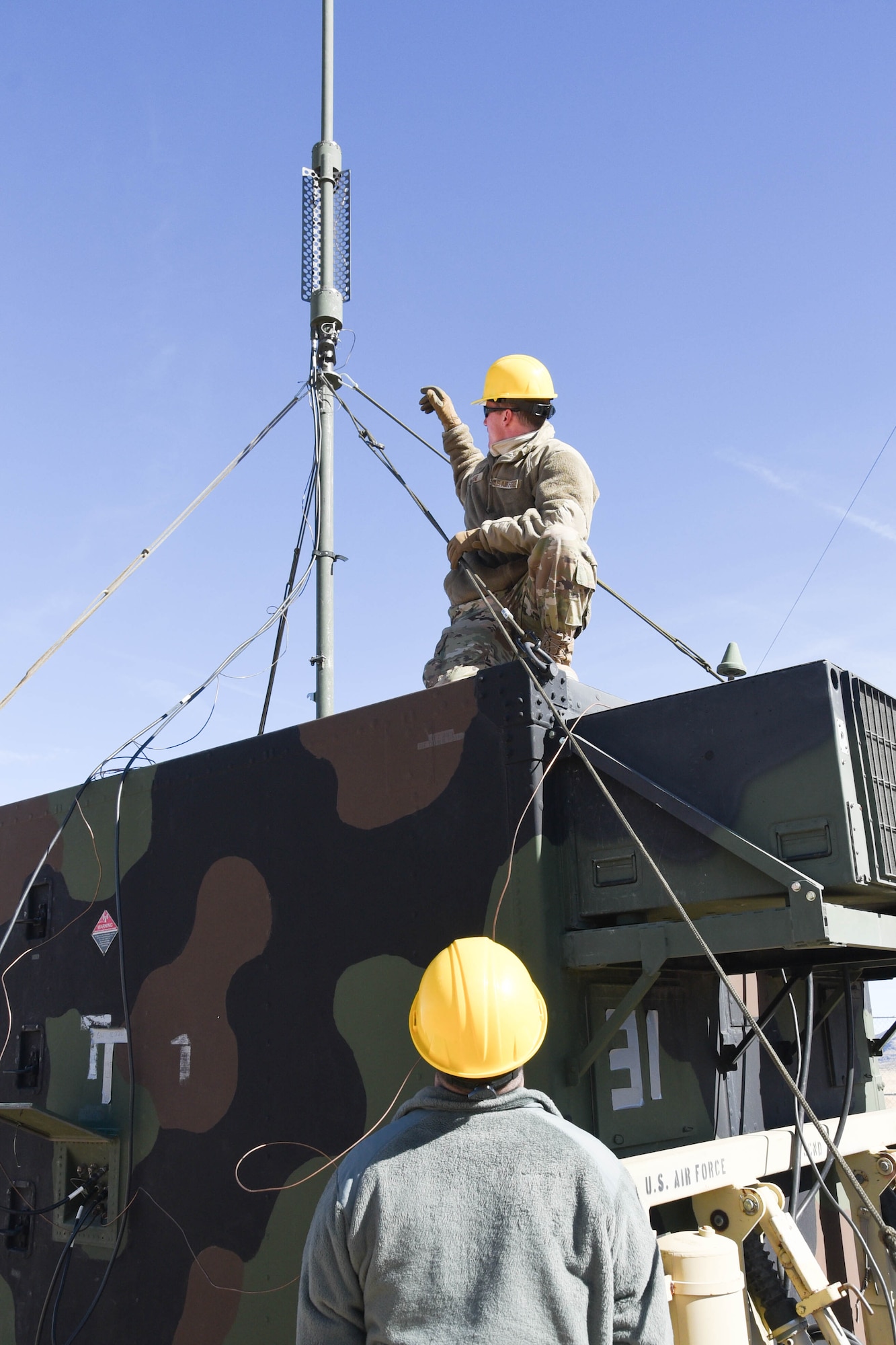 On the ground at Nellis Air Force Base, Nevada, Battle Manager Crews from the 729th Air Control Squadron working in a Control and Reporting Center are engaged in directing the Airspace for Red Flag 20-1; More than 100 miles away, members of the same unit built a deployed radar site in the middle of the desert to supplement the Command and Control systems used to direct the airspace of RED FLAG 20-1 (U.S. Air Force photo by 2d Lt. Ashlyn K. Paulson).