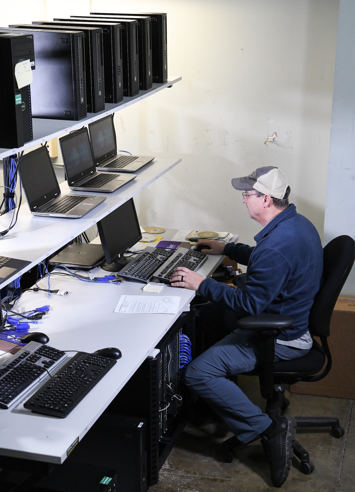 Troy Haywood, lead computer network technician, restages a computer for Non-Classified Internet Protocol Router Network, Dec. 12, 2019, in the PC Staging Area at Arnold Air Force Base, Tenn. Computers must be loaded with required software and necessary security protocols prior to being deployed for use by AEDC team members. (U.S. Air Force photo by Jill Pickett)