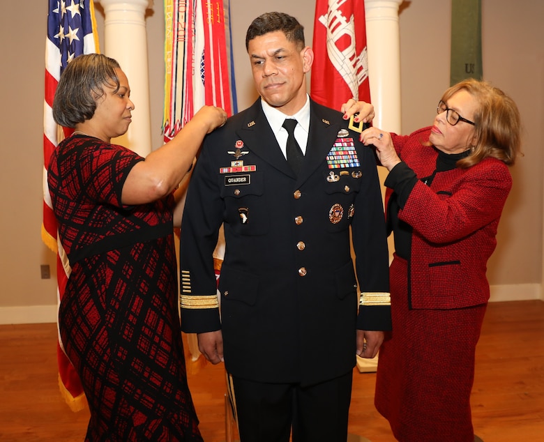 Brig. Gen. Mark Quander’s new rank is pinned to his uniform by his wife, Lt. Col. (ret.) Melonie Quander (left) and his mother Gail. Brig. Gen. Quander is the Commandant of the U.S. Army Engineer School at Fort Leonard Wood, Missouri, but was promoted during a ceremony at Joint Base Myer-Henderson Hall in Arlington, Virginia, on Feb. 14, 2020.