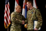 U.S. Army Maj. Gen. John C. Harris, the Ohio Adjutant General, congratulates U.S. Air Force Master Sgt. Ryan Tucker after Lt. Gov. Jon Husted awarded Tucker the Ohio Cross at the Ohio National Guard’s Joint Senior Leaders Conference Feb. 14, 2020, in Columbus, Ohio. The Ohio Cross is awarded to any member of the state military forces who distinguishes themselves by gallantry and intrepidity at the risk of their life.