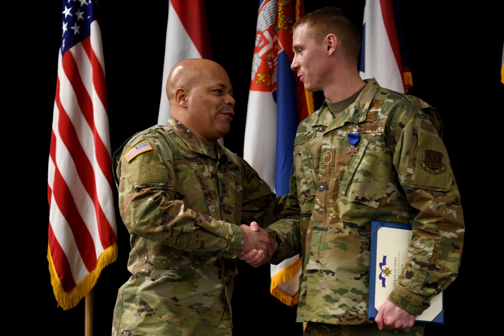 U.S. Army Maj. Gen. John C. Harris, the Ohio Adjutant General, congratulates U.S. Air Force Master Sgt. Ryan Tucker after Lt. Gov. Jon Husted awarded Tucker the Ohio Cross at the Ohio National Guard’s Joint Senior Leaders Conference Feb. 14, 2020, in Columbus, Ohio. The Ohio Cross is awarded to any member of the state military forces who distinguishes themselves by gallantry and intrepidity at the risk of their life.