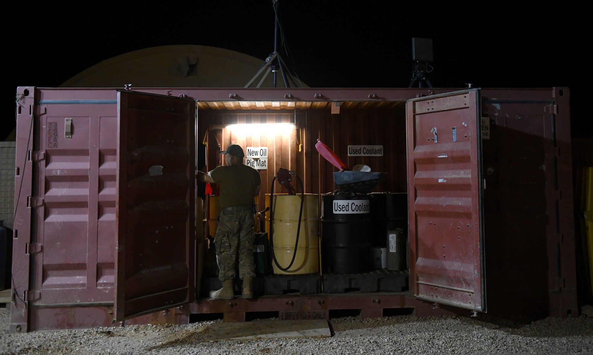Photo of Airmen performing preventative maintenance on a generator.