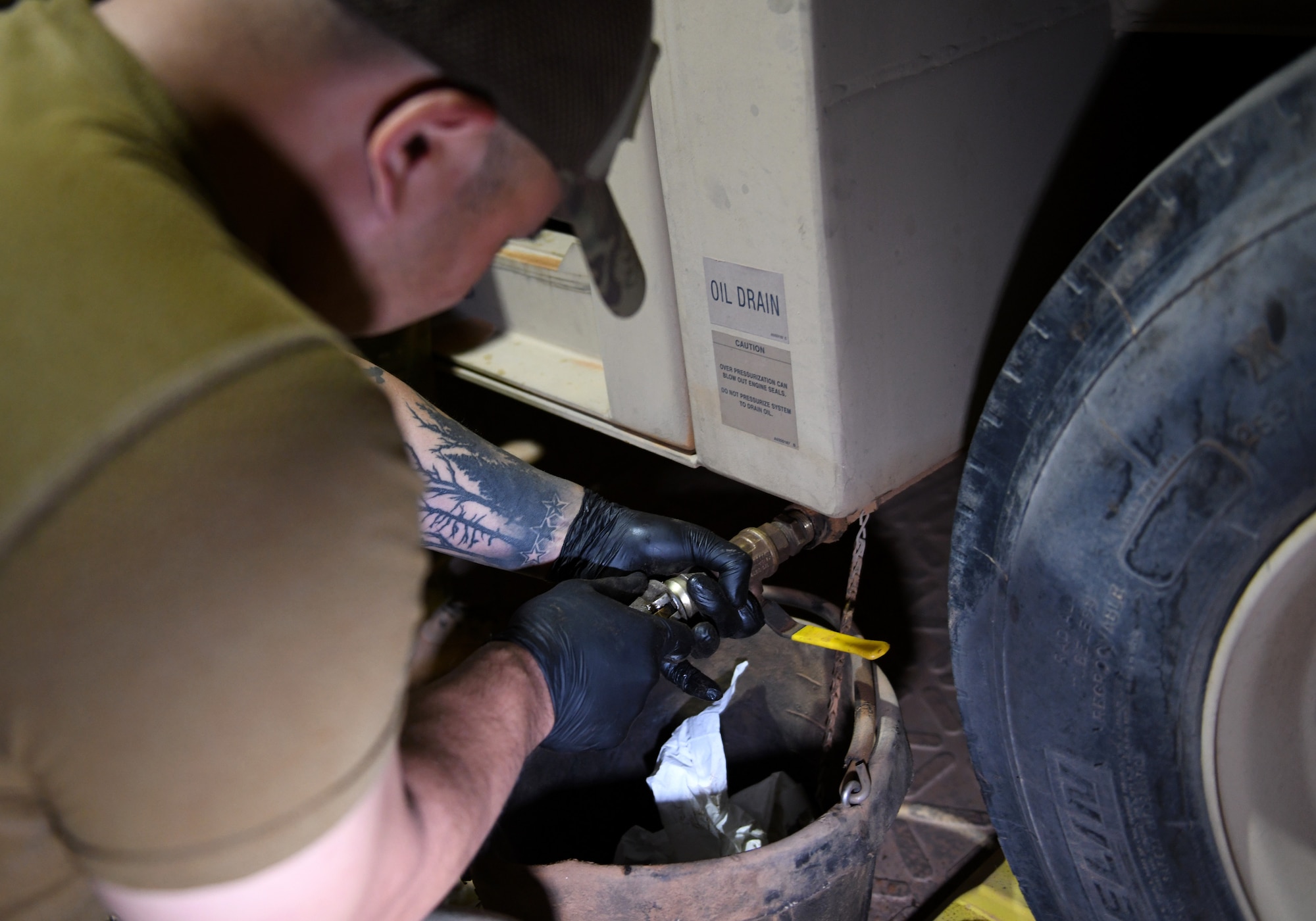 Photo of Airmen performing preventative maintenance on a generator.