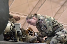 Cpl. Molly Campbell, UH-60 helicopter repairer, 1107th Theater Aviation Sustainment Maintenance Group, works on a UH-60 helicopter at Camp Buehring, Kuwait, Feb. 11, 2020.