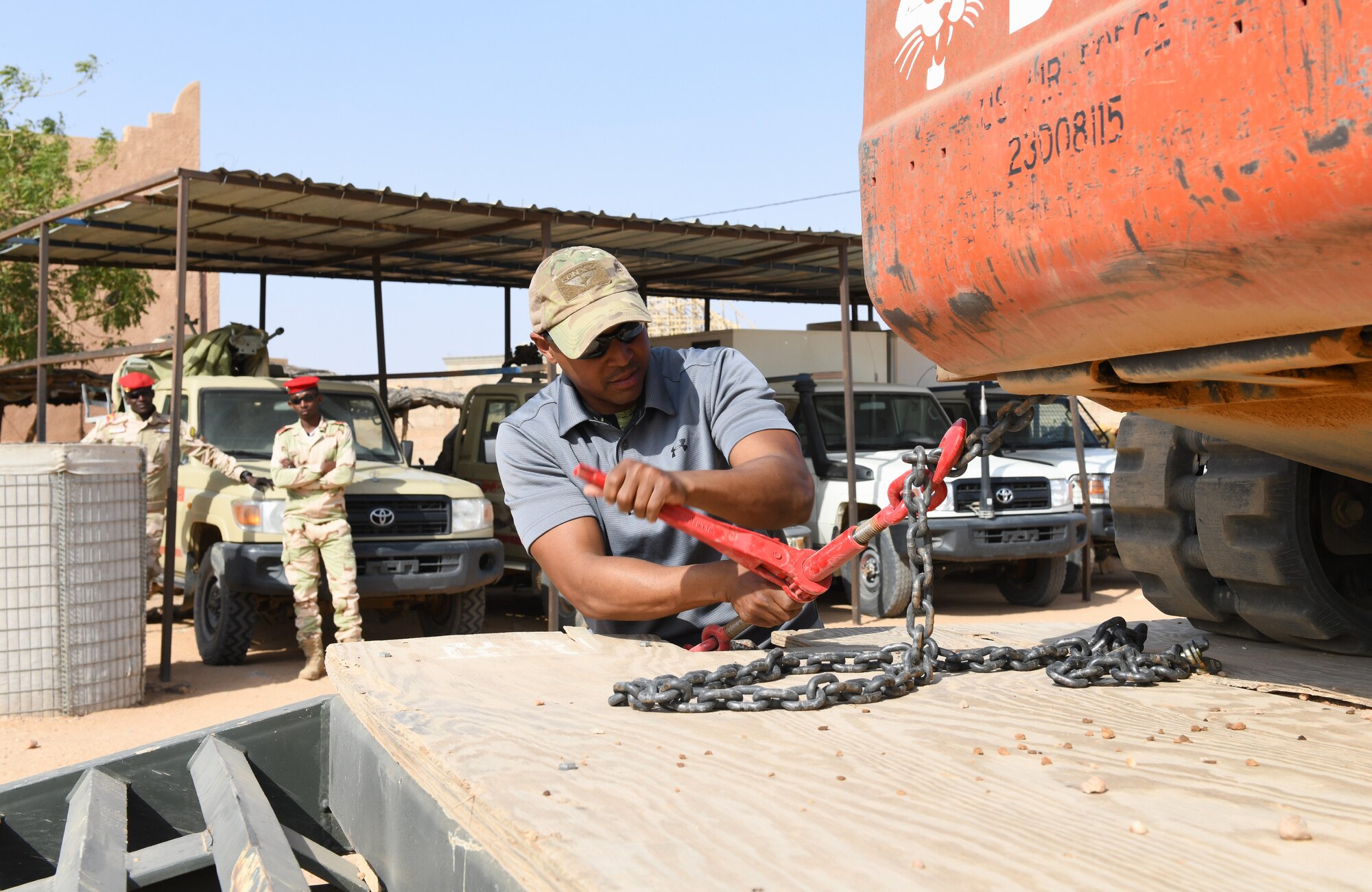 Photo of Airmen delivering protective barriers to help fortify a National Guard of Niger’s compound.