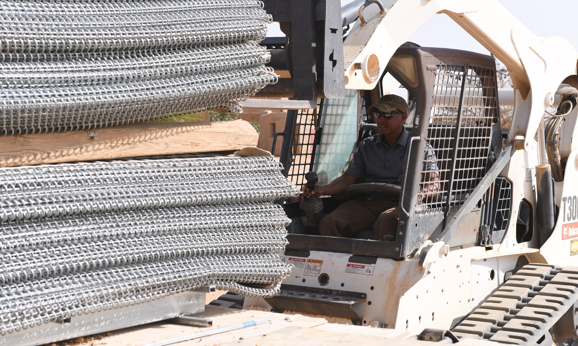 Photo of Airmen delivering protective barriers to help fortify a National Guard of Niger’s compound.