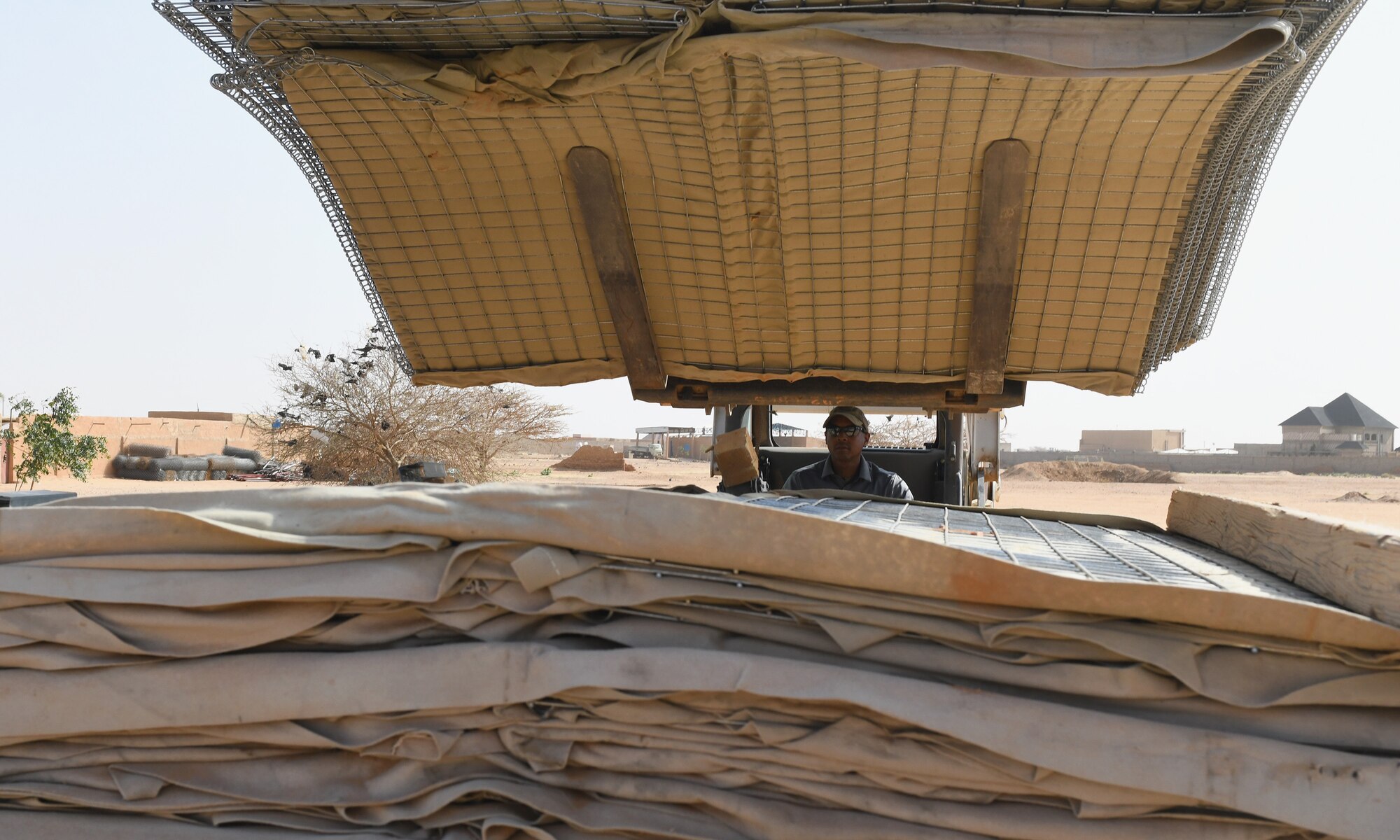 Photo of Airmen delivering protective barriers to help fortify a National Guard of Niger’s compound.