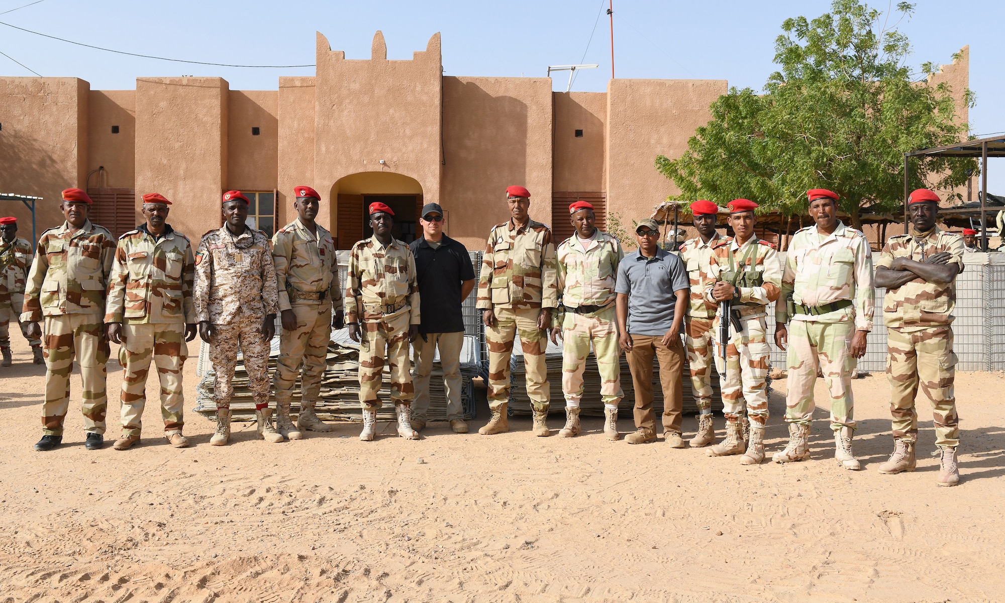 Photo of Airmen delivering protective barriers to help fortify a National Guard of Niger’s compound.