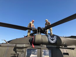 Soldiers of the 1107th Theater Aviation Sustainment Maintenance Group work on a UH-60 (Black Hawk) helicopter at Camp Buehring, Kuwait, Jan. 28, 2020. (Courtesy photo)