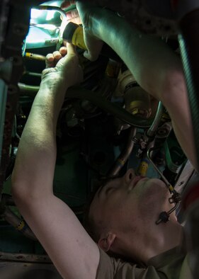 Airman 1st Class Cote Bidwell, 4th Equipment Maintenance Squadron inspection section journeyman, removes a utility reservoir from an F-15E Strike Eagle, Feb. 4, 2020, at Seymour Johnson Air Force Base, N.C.