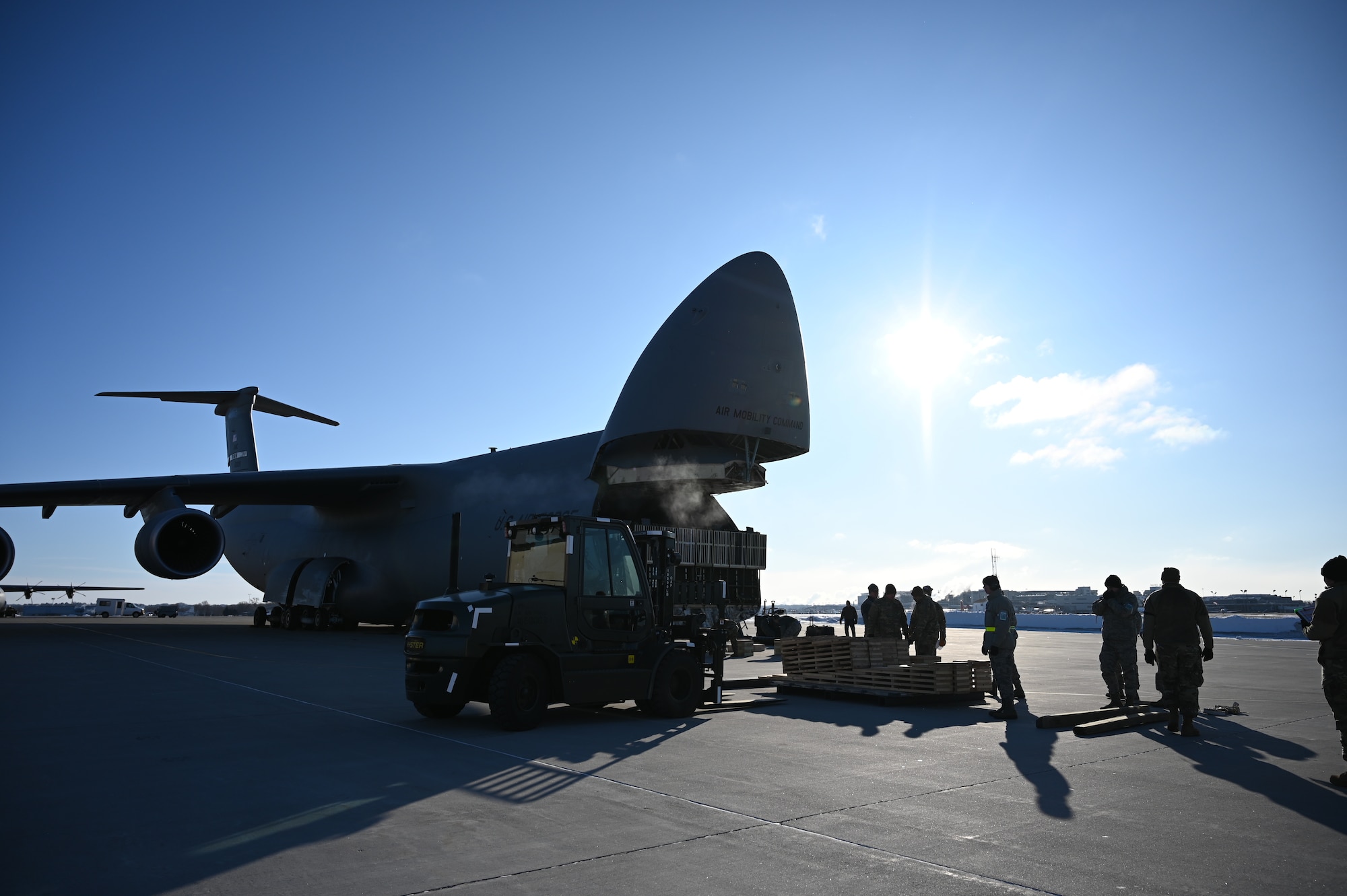 Airmen load vehicles into aircraft