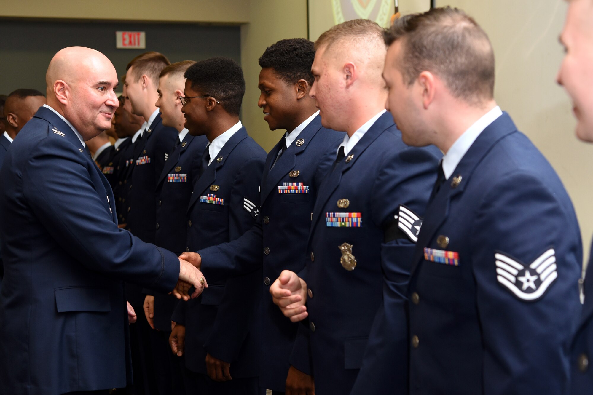 U.S. Air Force Col. Robert Ramirez, 17th Training Wing vice commander, personally congratulates Airman Leadership School graduates at the graduation ceremony in the event center at Goodfellow Air Force Base, Texas, Feb. 13, 2020. Sixteen Airmen attended ALS, where they learned supervisory duties, written and oral communication skills and the profession of arms. (U.S. Air Force photo by Airman 1st Class Abbey Rieves)