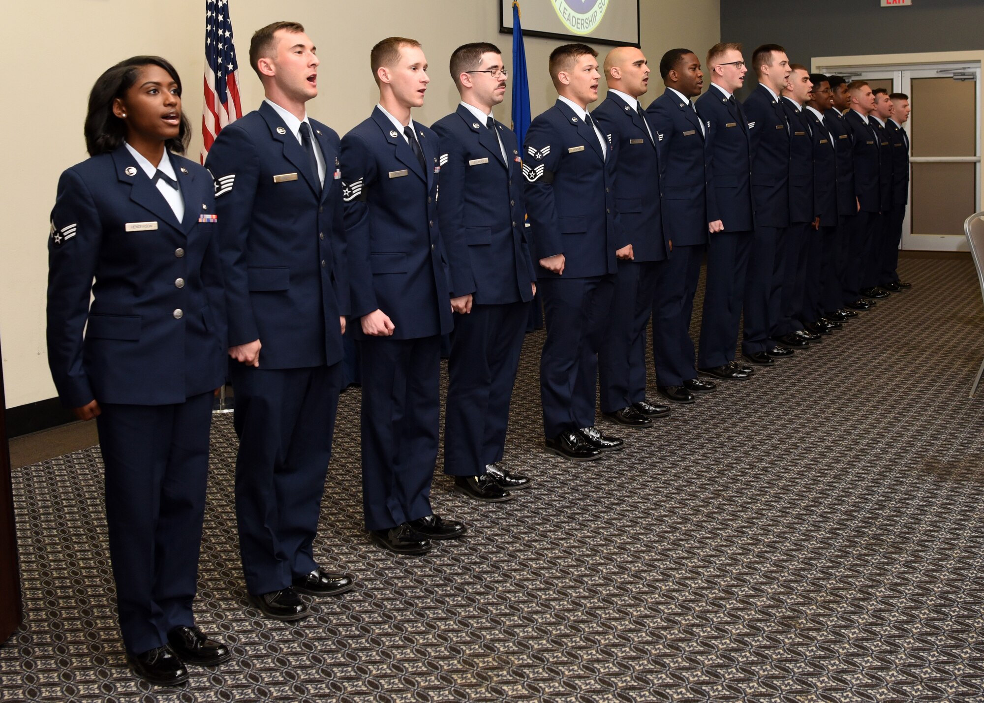 U.S. Air Force Airman Leadership School graduates sing the Air Force song during the ALS Graduation Ceremony in the event center at Goodfellow Air Force Base, Texas, Feb. 13, 2020.  The graduates charge the attendees to join in with singing, in recognition to Air Force heritage and honor. (U.S. Air Force photo by Airman 1st Class Abbey Rieves)