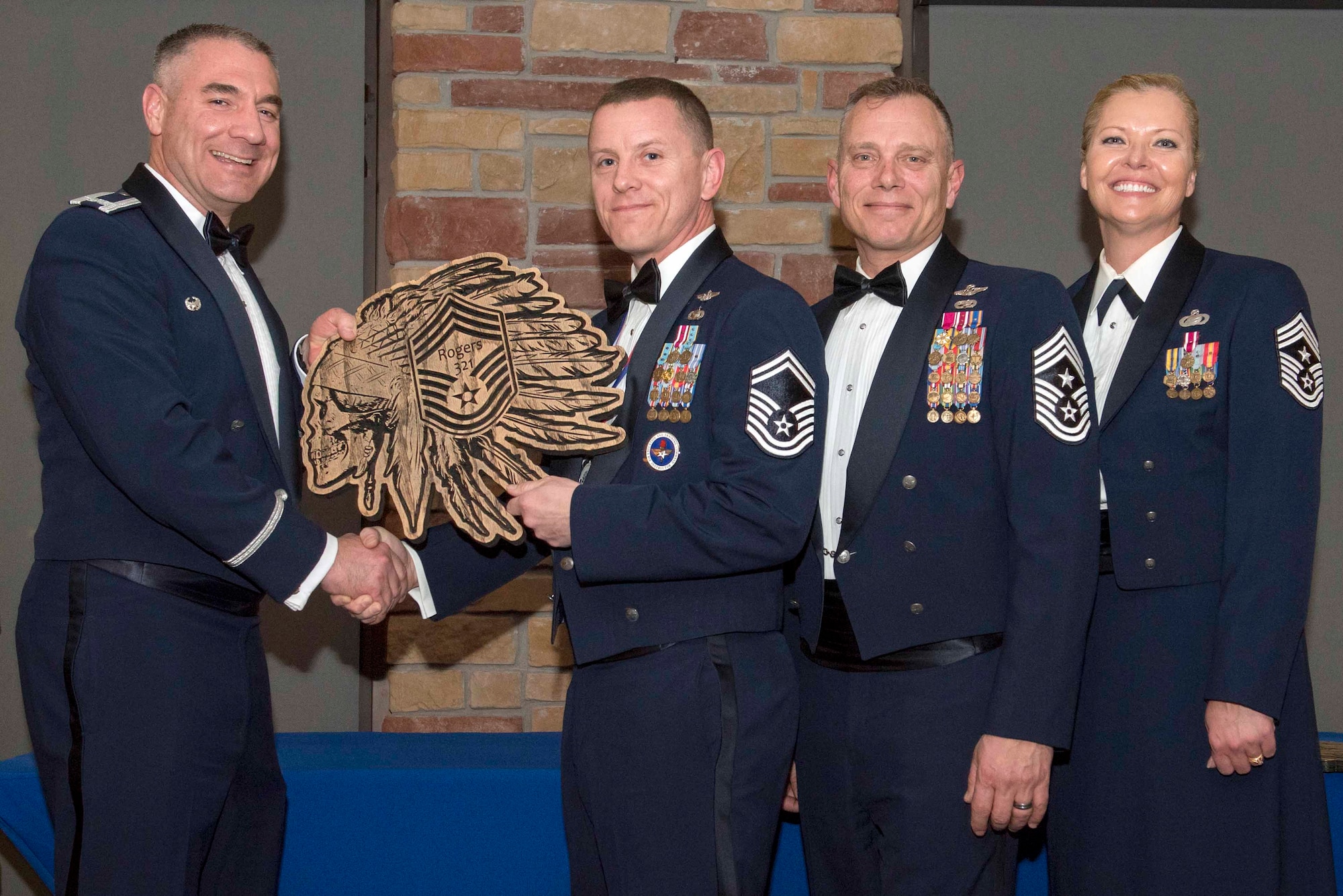 Senior Master Sgt. Brian Rogers, 491st Attack Squadron superintendent, accepts a plaque during the Chief Recognition Ceremony, Feb. 15, 2020, on Holloman Air Force Base, N.M. Eight individuals from Team Holloman were recognized during the formal ceremony and dinner. (U.S. Air Force photo by Staff Sgt. Christine Groening)
